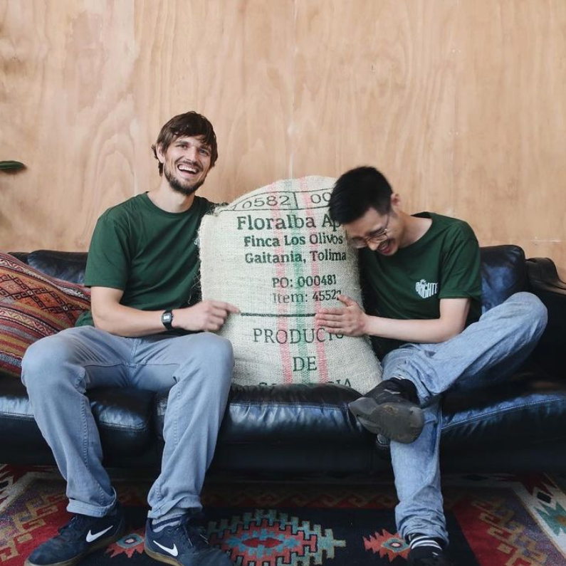 
                  
                    Load image into Gallery viewer, Made of Many Team holding a bag of bean coffee 
                  
                